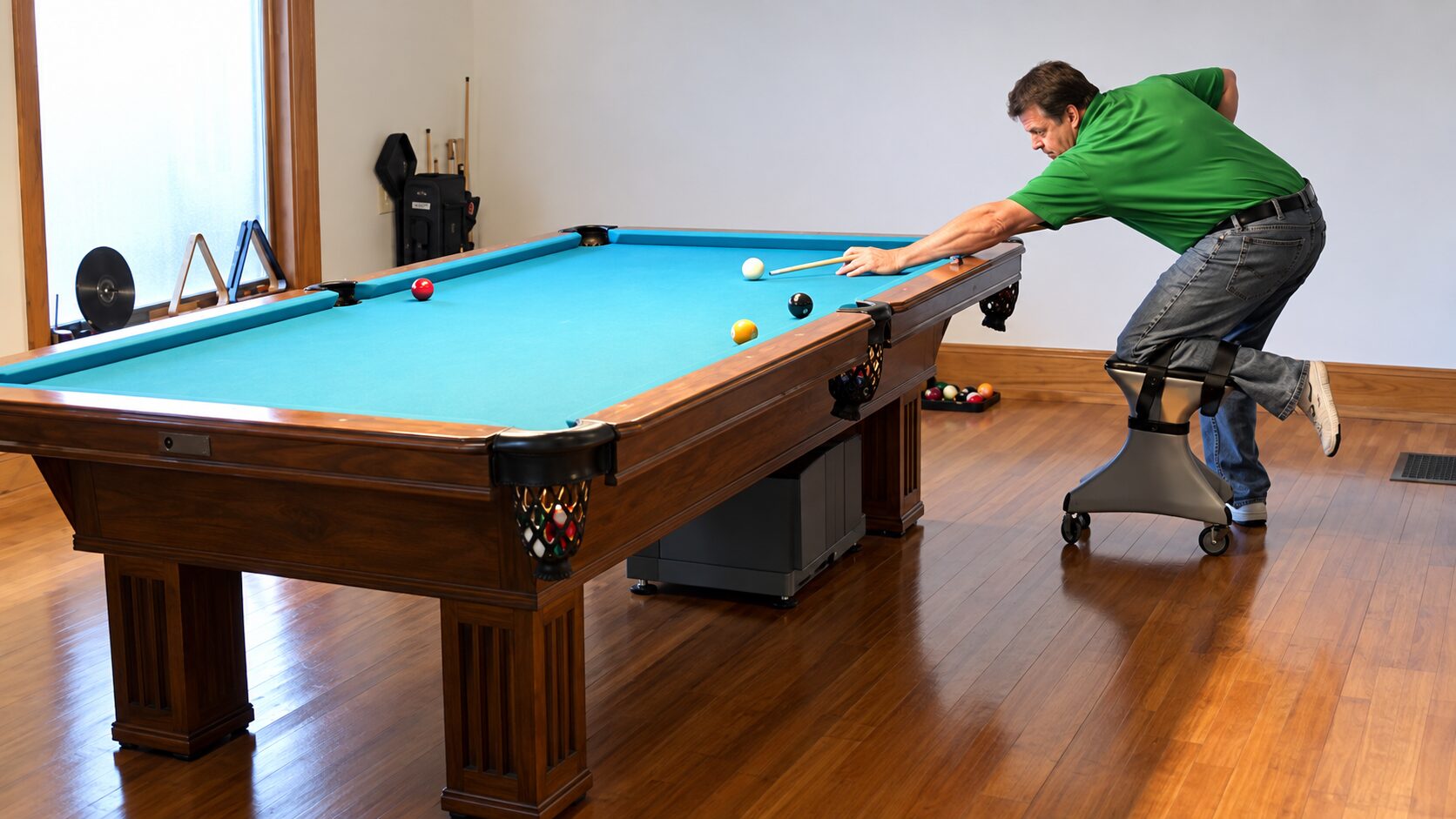 Man using RollerFoot hands-free knee scooter while playing billiards